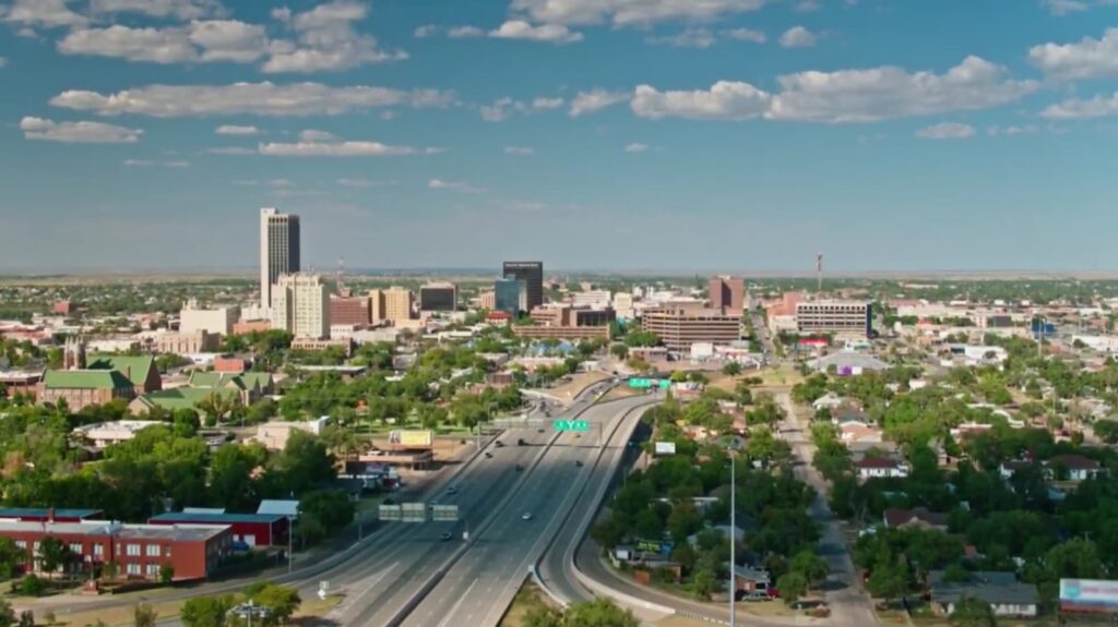 An aerial shot of a vibrant city cradled by the open landscape